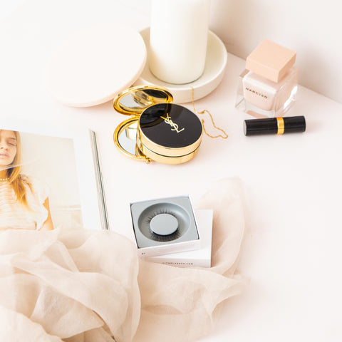 Blog_Lithe Lashes_ 5 Ways to Practice Self-Care_ Featured Image_Flatlay image of lithe lashes in white reusable box, next to white/pinkish props, and makeup and cosmetic products