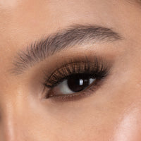 Lithe Lashes Bold Collection Style B4 - Wispy & Bold, a close up eye thumbnail image of the model's eye wearing the false lashes for an up close perspective on how elegant the falsies look on the eye.