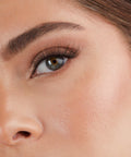 Lithe Lashes Core Collection lash style named 03 Everyday Winged, an image of a model’s face wearing lithe lashes on both eyes, with full makeup, looking from a left side profile, semi zoomed in, displaying the elegance of the lashes on her eyes.