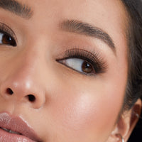 Lithe Lashes Core Collection lash style named 07 Long and 3-Dimensional, an image of a model’s face wearing lithe lashes on both eyes, with full makeup, looking from a left side profile, semi zoomed in, displaying the elegance of the lashes on her eyes.