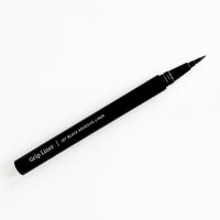 Lithe Lashes false lashes accessories Grip Liner, a 2-in-1 eyeliner lash adhesive. the matte black bottle is open on a white background, showing the ultra fine tip for easy application.